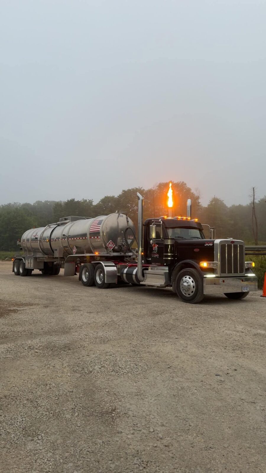 Titan Oil truck 306 in morning fog with a gas flare behind