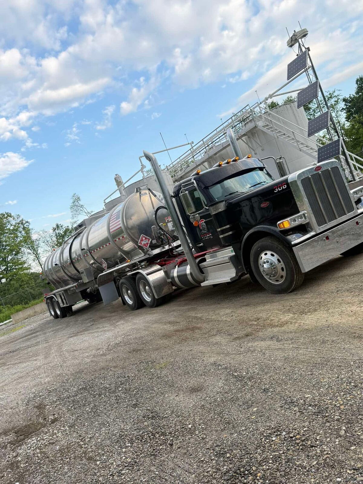 Titan Oil truck 306 with crude tanker at a tank farm
