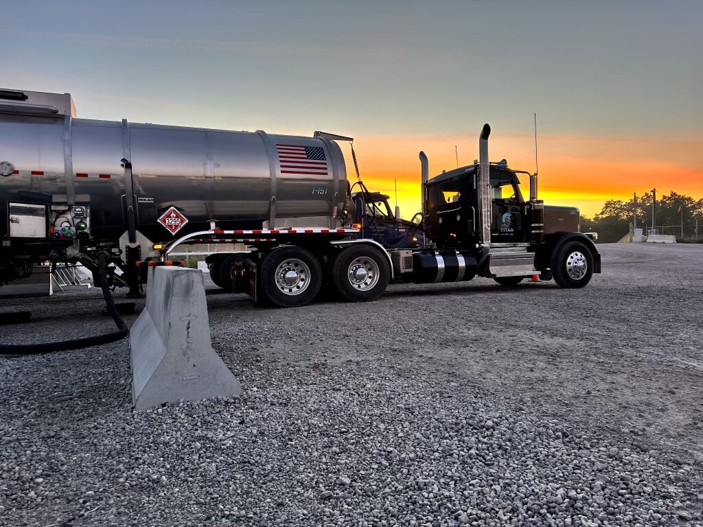 Titan Oil truck 311 at a gravel pad at sunrise
